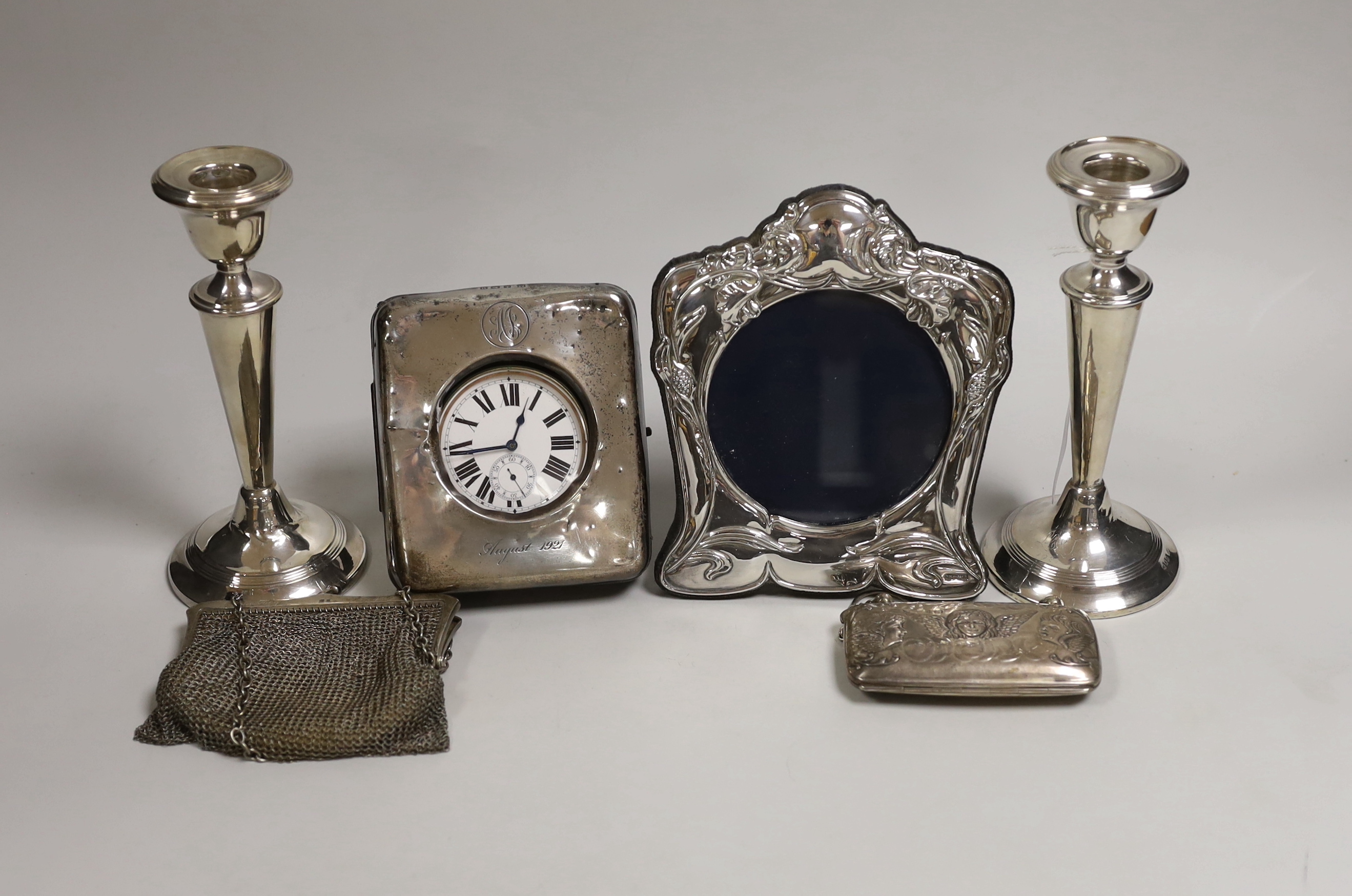 Mixed silver including a pair of George V mounted candlesticks, London, 1919, 17.4cm, travelling pocket watch case, purse, mesh bag and a modern photograph frame.